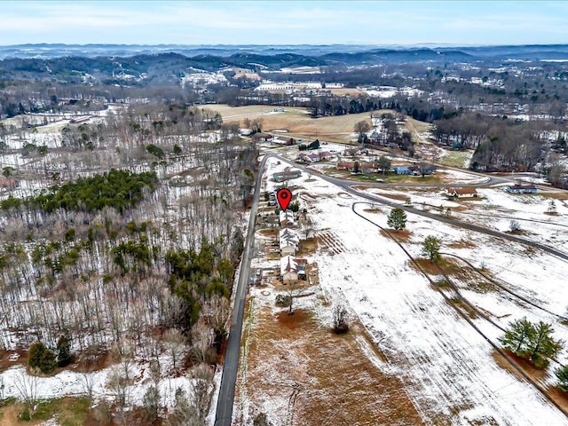 snowy aerial view with a mountain view