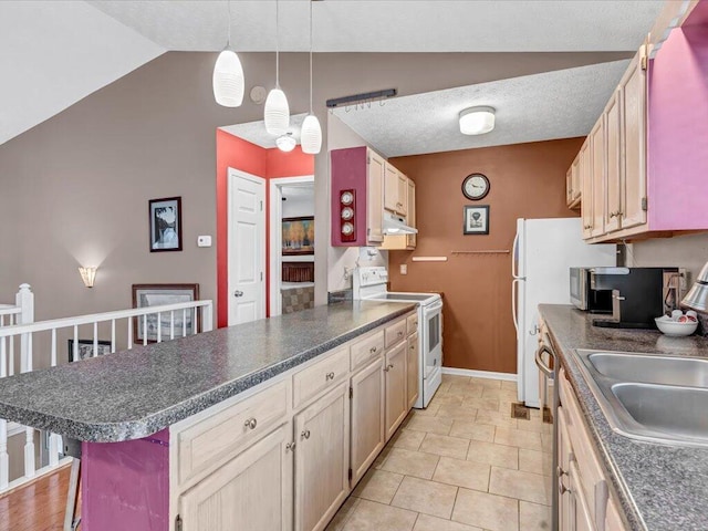 kitchen featuring light brown cabinetry, stainless steel appliances, lofted ceiling, and sink