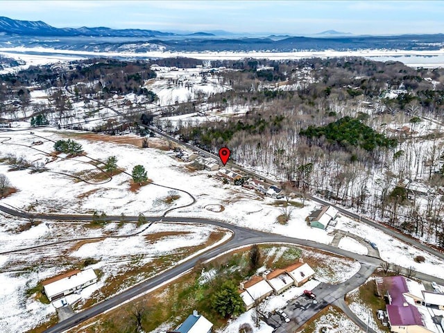 snowy aerial view with a mountain view