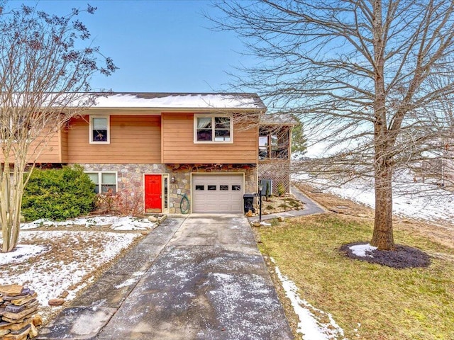 bi-level home featuring a garage