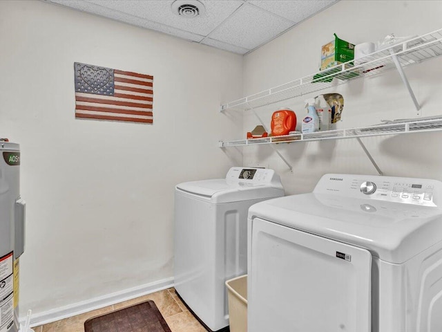 washroom with light tile patterned floors, water heater, and washer and dryer