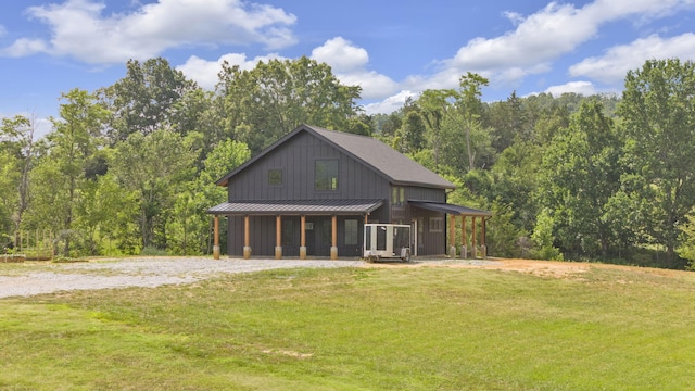 back of property featuring a lawn