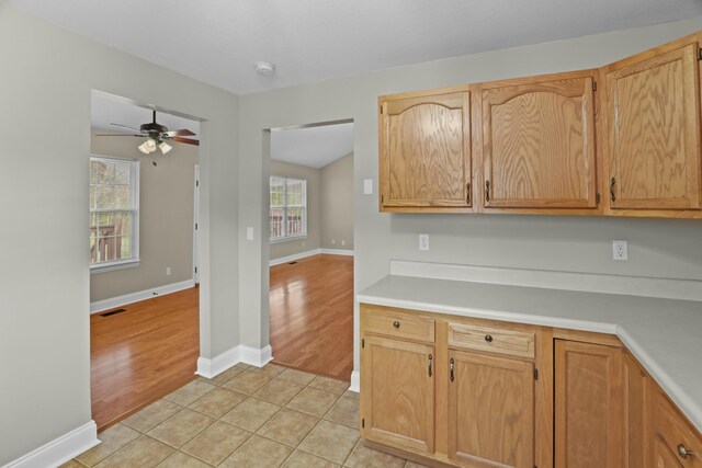 749 Harvest Meadows Dr, Kodak, TN 37764 - kitchen featuring light tile patterned floors, visible vents, baseboards, light countertops, and ceiling fan
