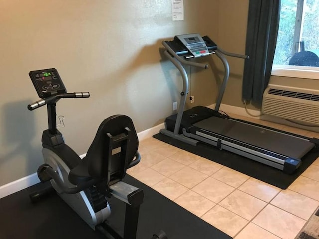 exercise area featuring light tile patterned flooring