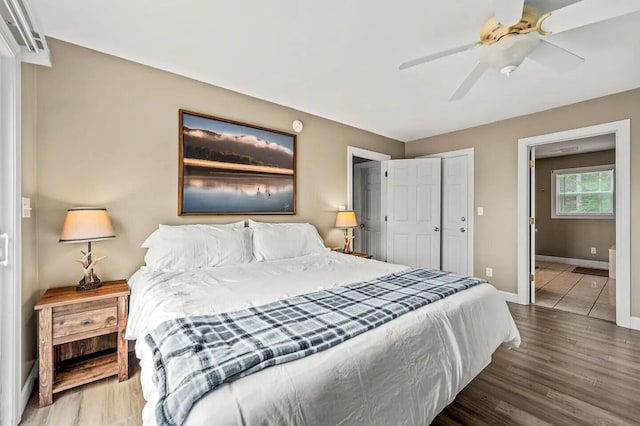 bedroom featuring hardwood / wood-style flooring, ceiling fan, and a closet