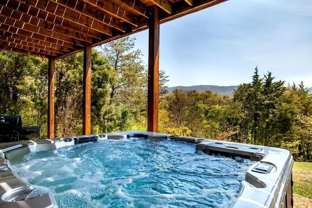 view of pool with a hot tub