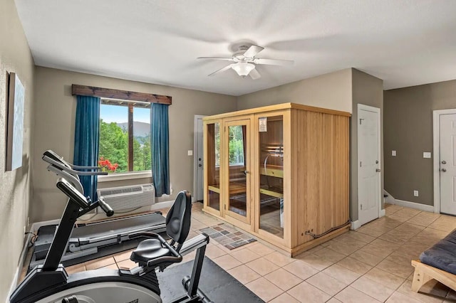 exercise room featuring light tile patterned floors and ceiling fan