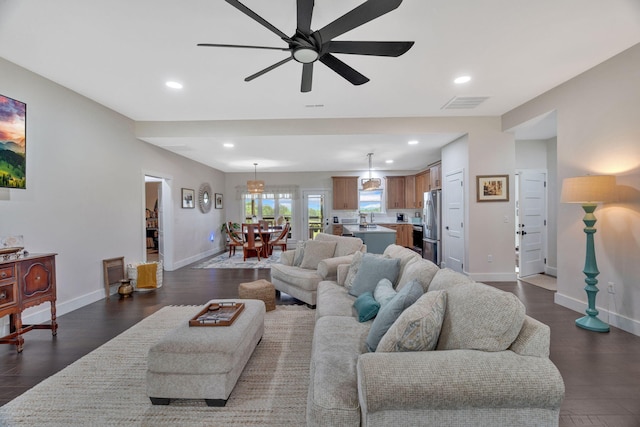 living area featuring recessed lighting, baseboards, ceiling fan, and dark wood-style flooring