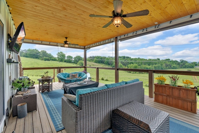 deck featuring outdoor lounge area, ceiling fan, and a lawn
