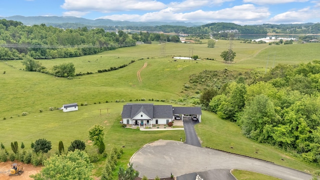 aerial view of sparsely populated area with agricultural land and a mountainous background