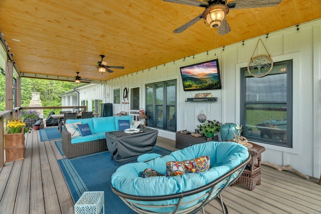 wooden terrace featuring an outdoor living space and a ceiling fan