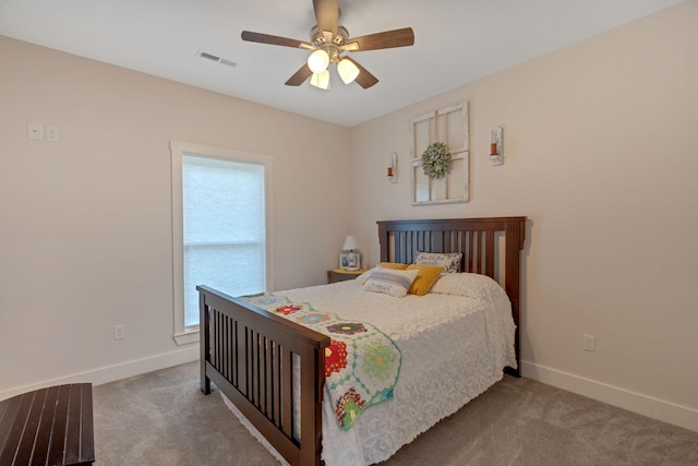 bedroom featuring carpet floors, multiple windows, baseboards, and a ceiling fan