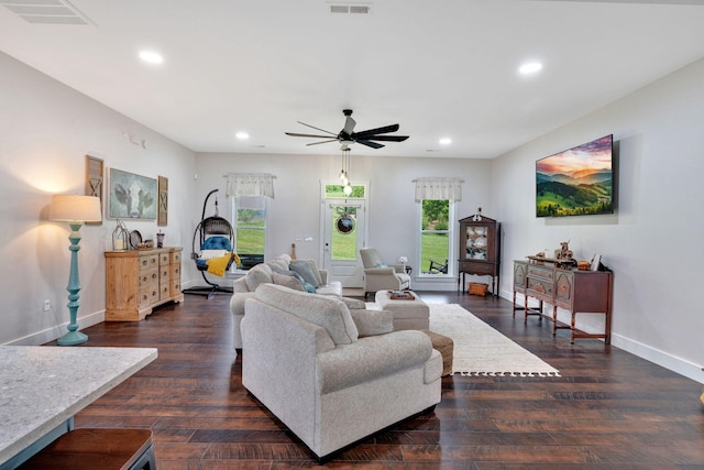 living room featuring ceiling fan, recessed lighting, baseboards, and dark wood-type flooring