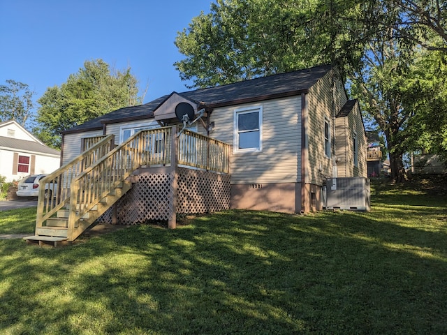 back of house with a yard and crawl space