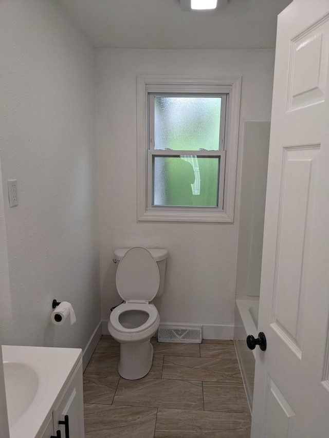 full bathroom with toilet, a bathtub, vanity, visible vents, and baseboards