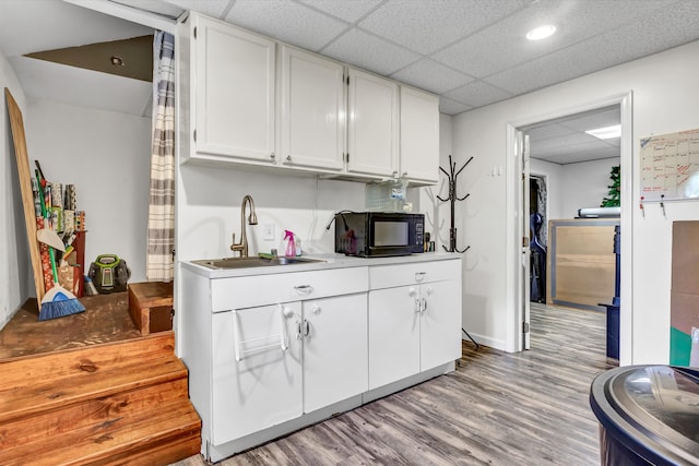 1651 Old Liberty Hill Rd, Morristown, TN 37814 - kitchen featuring black microwave, a sink, white cabinets, light wood finished floors, and light countertops