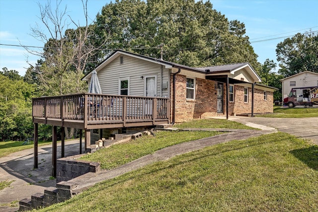 1651 Old Liberty Hill Rd, Morristown, TN 37814 - ranch-style home with brick siding, a deck, a front lawn, metal roof, and driveway