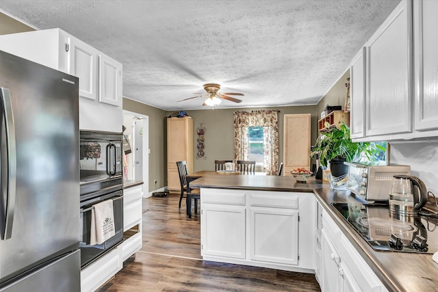 1651 Old Liberty Hill Rd, Morristown, TN 37814 - kitchen with black appliances, a peninsula, ceiling fan, white cabinets, and a textured ceiling