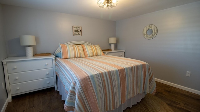 bedroom featuring baseboards and wood finished floors