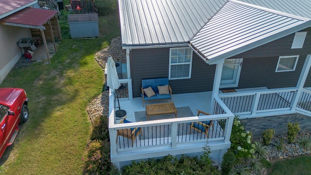 wooden deck with an outdoor hangout area and a yard