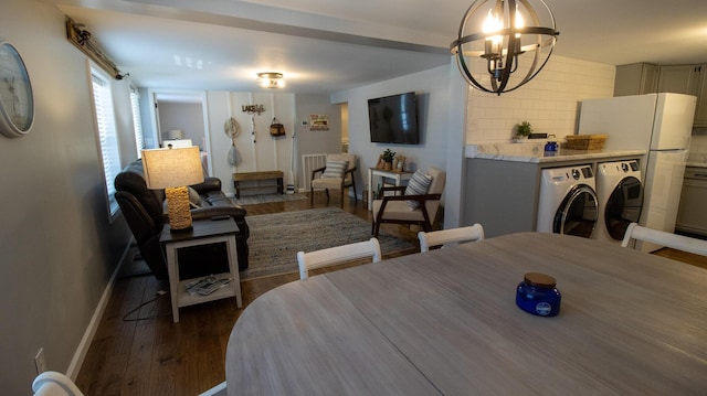 dining area featuring dark wood finished floors, an inviting chandelier, and baseboards