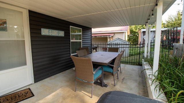 view of patio featuring outdoor dining space and fence