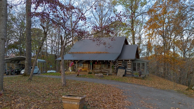 view of front of home with a carport and a porch