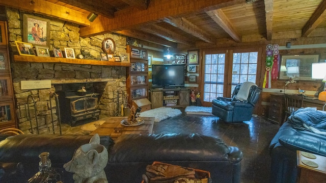 living room featuring beamed ceiling, a wood stove, and wooden ceiling