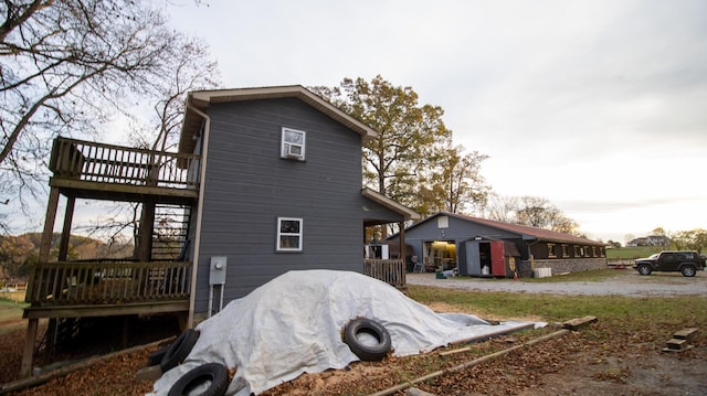 rear view of house featuring a wooden deck