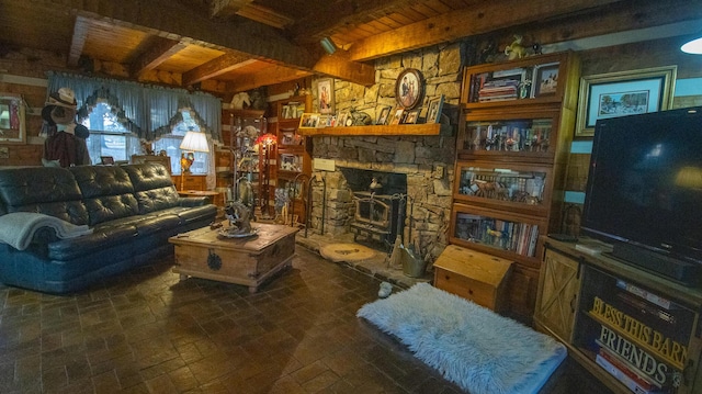 living room with beam ceiling, a wood stove, and wood ceiling