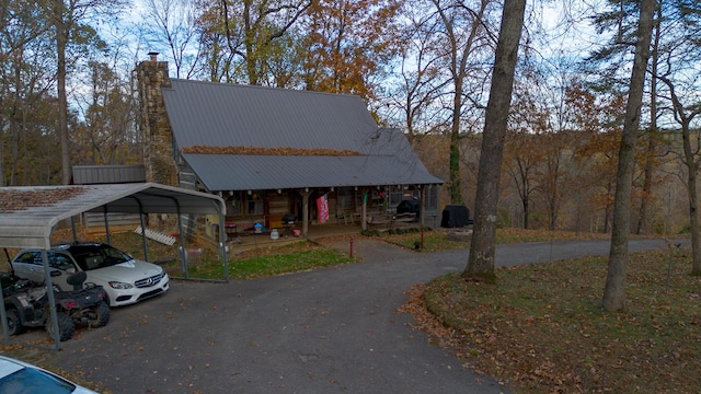 view of front of home with covered porch and a carport