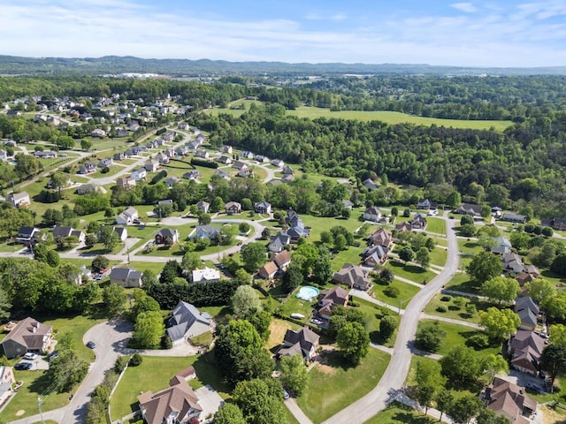 bird's eye view with a wooded view and a residential view
