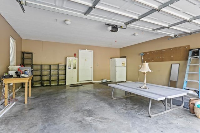 garage with freestanding refrigerator and a garage door opener