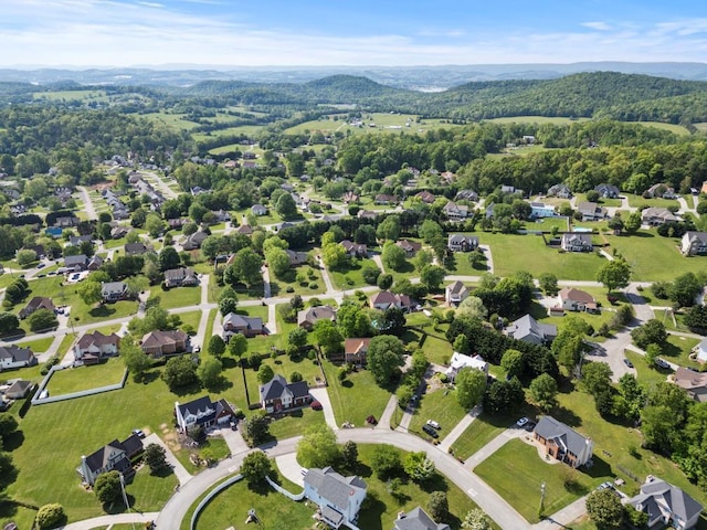 bird's eye view with a wooded view