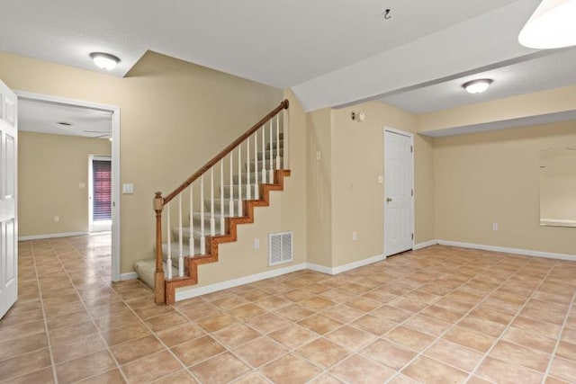 interior space with baseboards, tile patterned floors, and visible vents