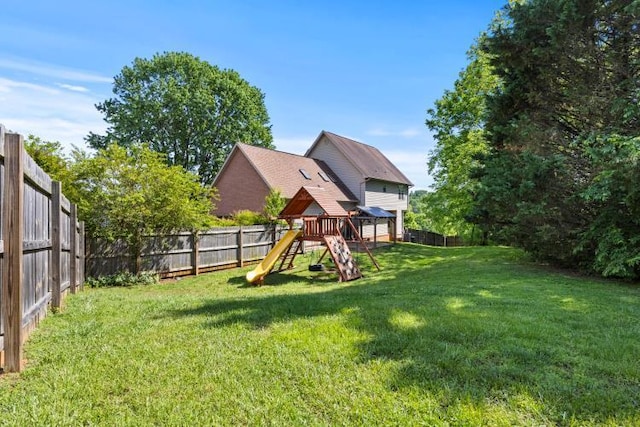 view of yard featuring a fenced backyard and a playground