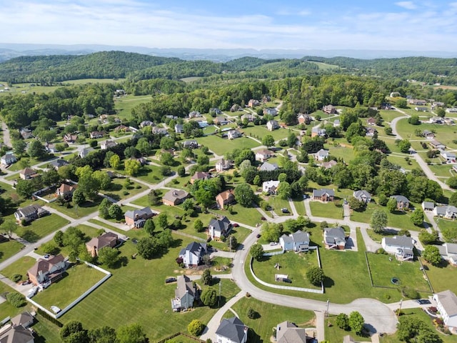 birds eye view of property featuring a view of trees