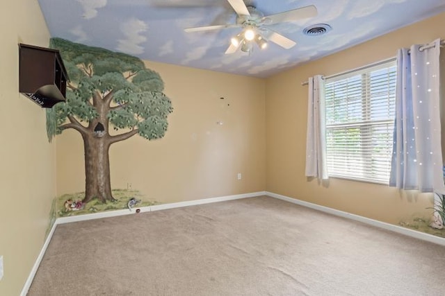 unfurnished room featuring baseboards, visible vents, a ceiling fan, and carpet floors
