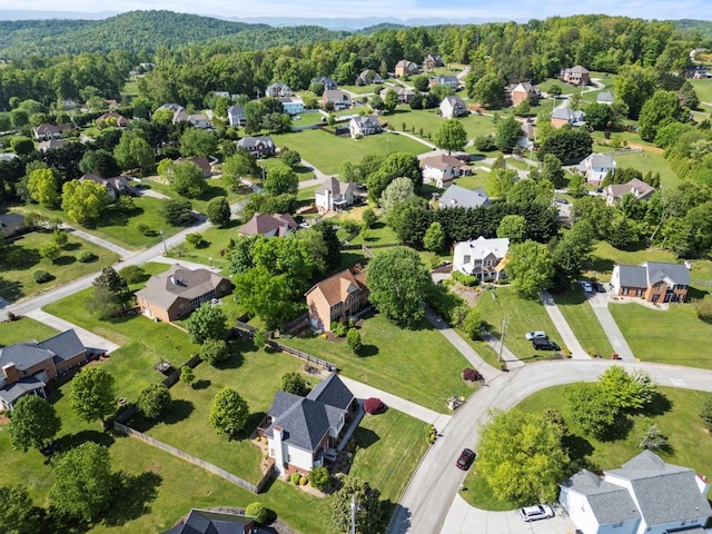drone / aerial view featuring a view of trees and a residential view