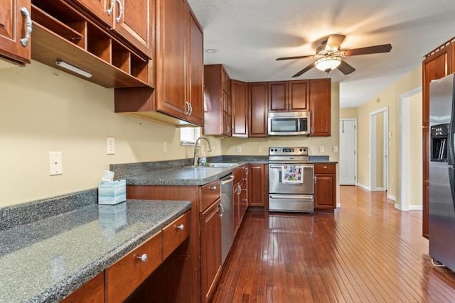 kitchen with dark wood-style flooring, ceiling fan, appliances with stainless steel finishes, and a sink