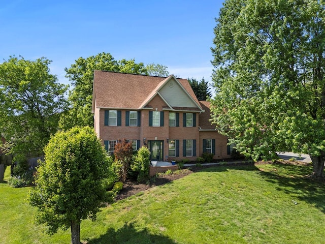 colonial-style house with brick siding and a front yard