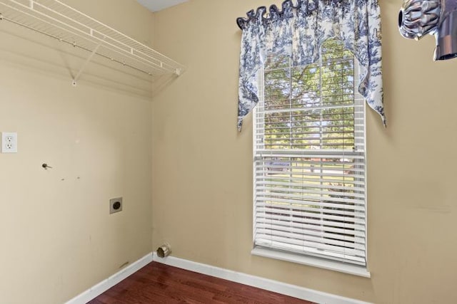 clothes washing area with laundry area, dark wood-type flooring, baseboards, and electric dryer hookup