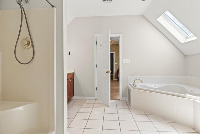 bathroom featuring vaulted ceiling with skylight, tile patterned floors, a bath, visible vents, and vanity