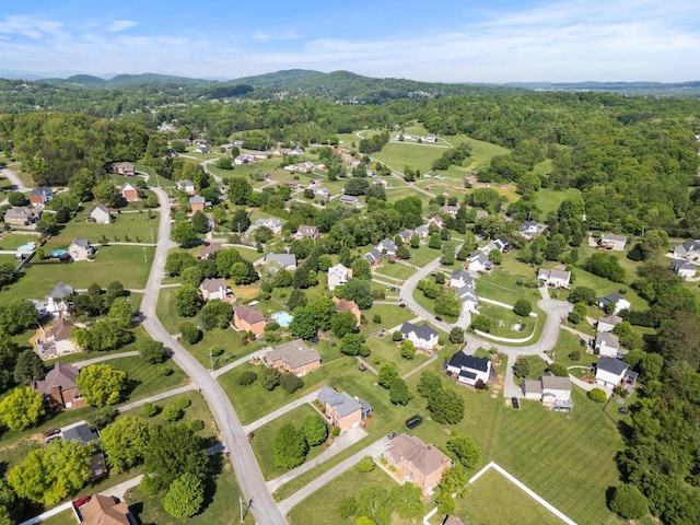 drone / aerial view featuring a wooded view and a mountain view