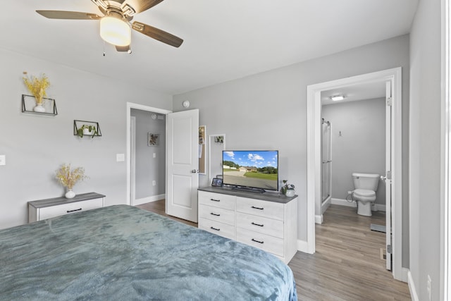 411 Mckinney Dr, Sevierville, TN 37876 - bedroom with ensuite bath, ceiling fan, baseboards, and wood finished floors