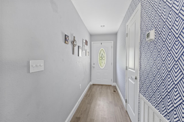 411 Mckinney Dr, Sevierville, TN 37876 - doorway to outside with visible vents, baseboards, wallpapered walls, and wood finished floors