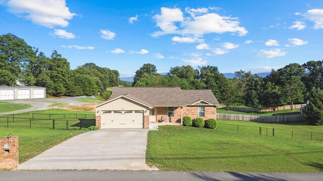 411 Mckinney Dr, Sevierville, TN 37876 - view of front of house with a garage, fence, a front lawn, brick siding, and driveway