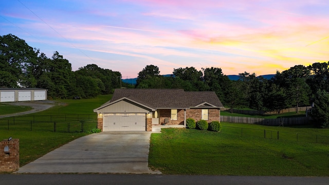 411 Mckinney Dr, Sevierville, TN 37876 - view of front of house with brick siding, concrete driveway, fence, and a front yard