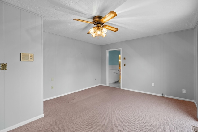 spare room featuring carpet floors, ceiling fan, and baseboards