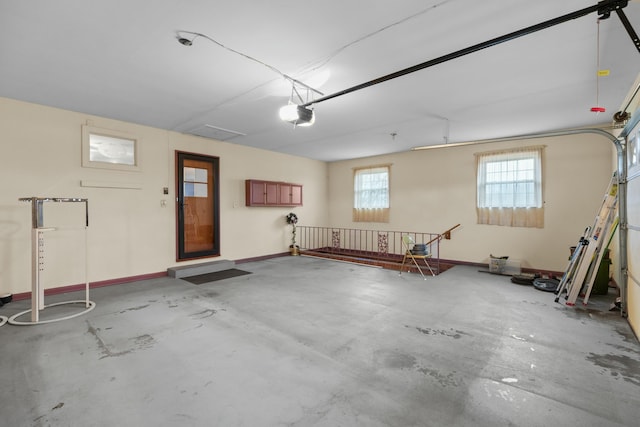 garage with baseboards and a garage door opener